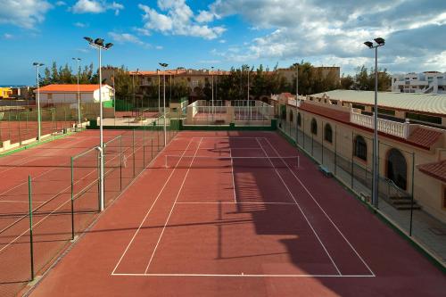 a tennis court with two tennis nets on it at Elba Lucía Sport & Suite Hotel in Costa de Antigua