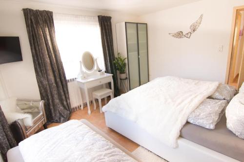 a bedroom with two beds and a mirror at Rust-Fewo-Hotel in Rust