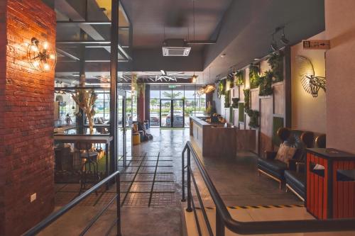 a lobby of a restaurant with a brick wall at V3 Hotel & Residence Seri Alam in Pasir Gudang