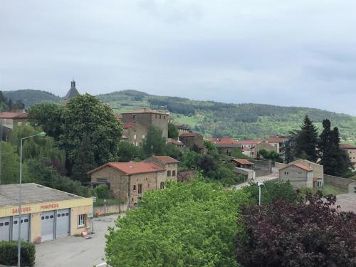 a small town with a mountain in the background at Le Felicien in Saint-Félicien