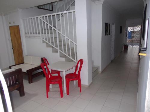 a room with a table and two chairs and a staircase at Hotel Monaco De Riohacha in Ríohacha