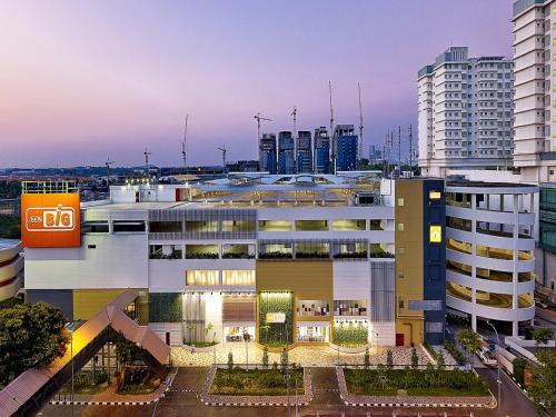 a large white building in a city with tall buildings at My Sj Hotel in Subang Jaya