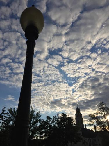 a street light in front of a cloudy sky at School 31 Lofts in Rochester