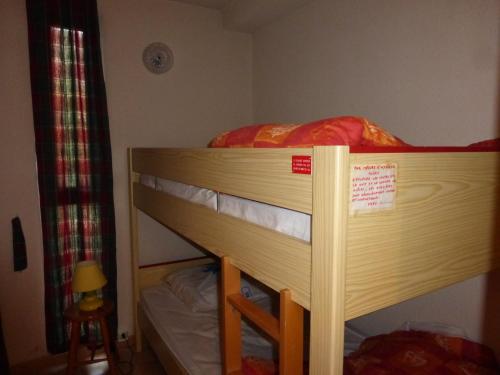 a bunk bed with a sign on the top of it at RESIDENCE UBAYE T 17 in Enchastrayes