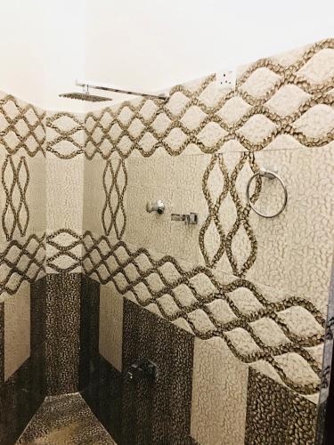 a bathroom with a rope on the wall at Travellers Halt in Ratnapura