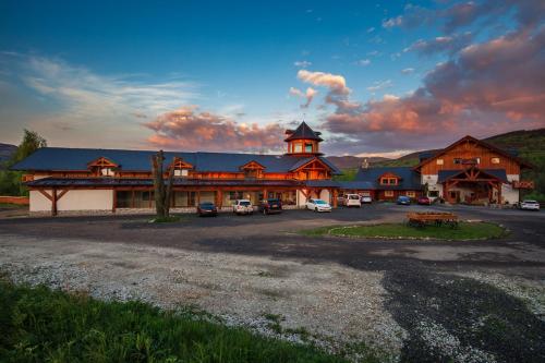 a large lodge with a parking lot in front of it at Rezidence u Jezera in Jeseník