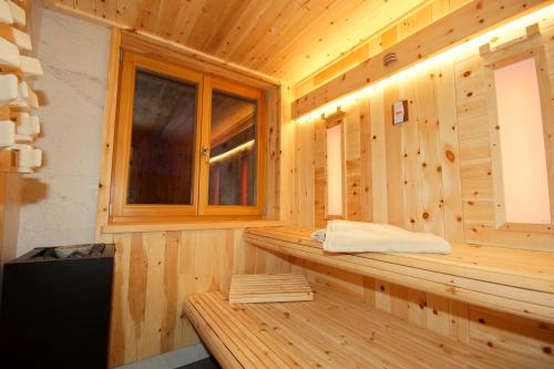 a sauna in a wooden cabin with a window at Chalet Frieda in Mühlbach
