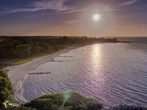 an aerial view of a beach at sunset at Ferienwohnung SEA in Vogelsang