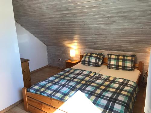 a bedroom with a bed with two pillows on it at Ferienwohnung Freitag in Gammendorf