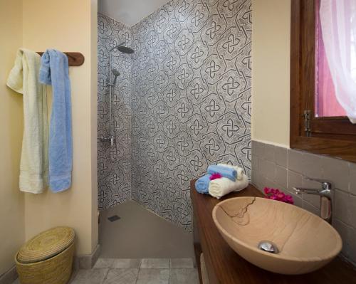 a bathroom with a sink and a shower at Zanziblue in Matemwe