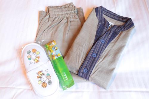 a pair of pants and a shirt and a toothbrush at TABINO HOTEL Hida Takayama in Takayama