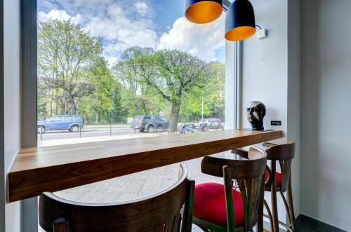 a large window in a room with a table and chairs at Ratusz B&B in Gdańsk