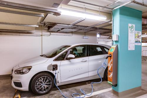 a white car is being charged in a garage at SEETELHOTEL Kaiserstrand Beachhotel das Lifestyle-Hotel direkt am Strand in Bansin