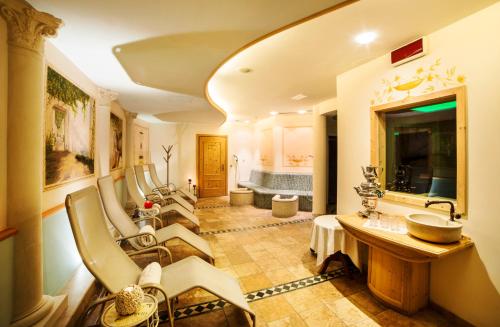 a large bathroom with a sink and a tub at Cavallino Lovely Hotel in Andalo