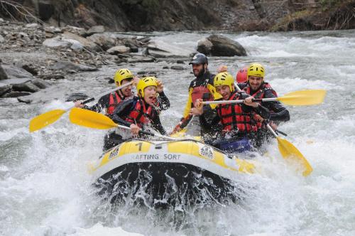 a group of people in a raft on a river at Camping Noguera Pallaresa in Sort