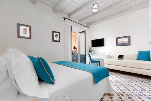 a bedroom with a bed and a living room at Palazzo delle Grazie in Sorrento