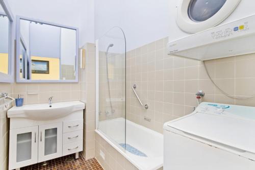 a bathroom with a sink and a shower at Beachpark 56 58 Pacific Drive in Port Macquarie