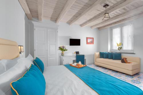 a living room with a large bed and a couch at Palazzo delle Grazie in Sorrento