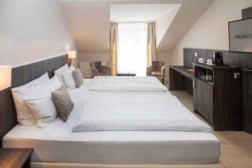 Ένα ή περισσότερα κρεβάτια σε δωμάτιο στο Hotel Twilling