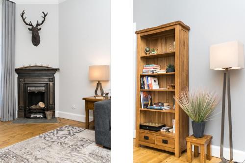 a living room with a fireplace and a living room with a fire place at Beautiful, Traditional 2 Bedroom Main Door Flat in Edinburgh