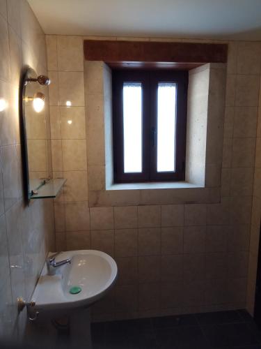 a bathroom with a sink and a window at Villa Cardia in Kiriánna