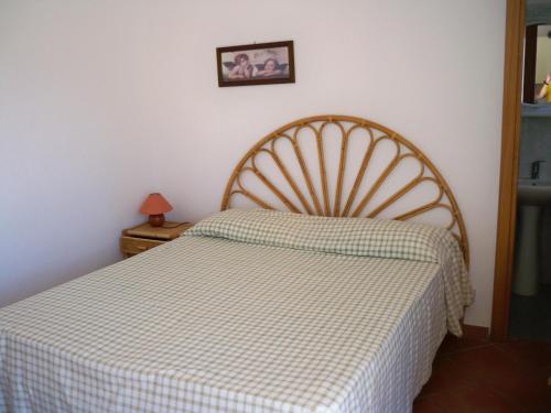a bedroom with a bed with a checkeredkered blanket at L'Isolana Case Vacanza Luna 1 in Ponza