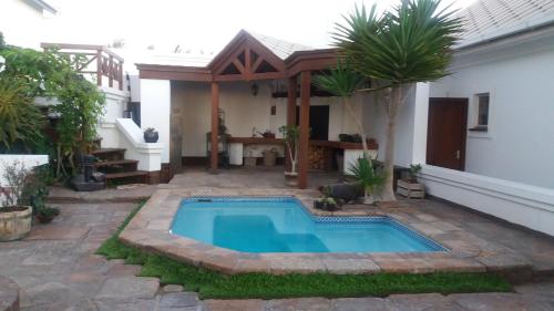 a swimming pool in front of a house at Haus Schaaf b&b in Walvis Bay