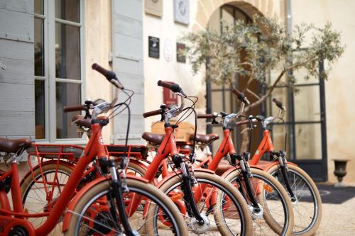 a row of orange bikes parked in front of a building at Domaine de Fontenille in Lauris