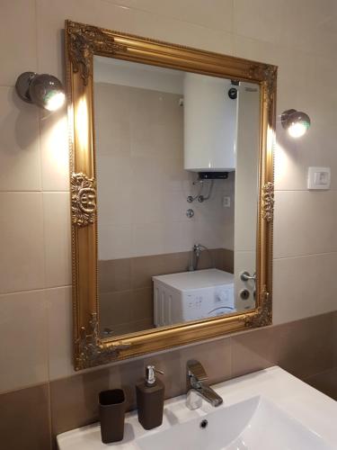 a bathroom with a mirror over a sink at Apartment Ulika in Marčana