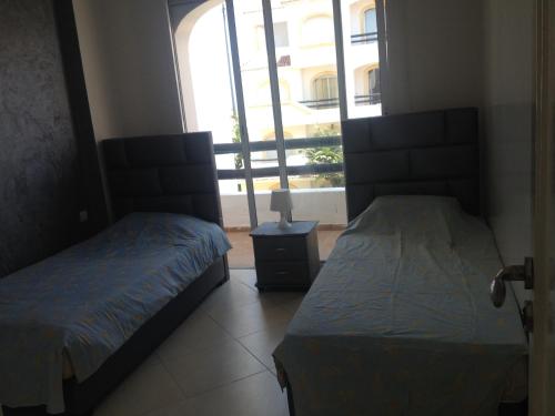 Ein Bett oder Betten in einem Zimmer der Unterkunft Garden Beach Sidi Rahal