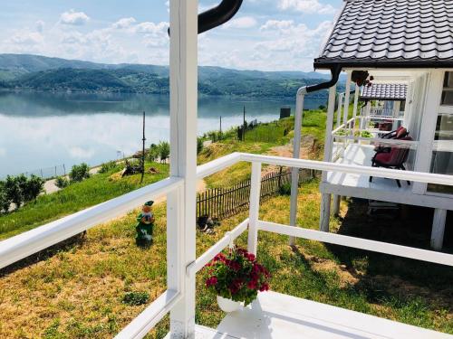 a view from the porch of a house overlooking a lake at Dream Tricule in Sviniţa