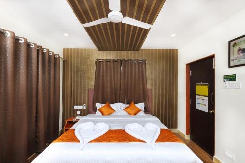 a bedroom with a bed with two hearts on it at Royal Grand in Tambaram