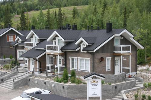 a large house with a sign in front of it at Vuokatin Aateli Apartments in Vuokatti