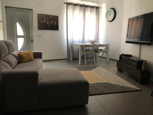 a living room with a couch and a table at Loft-Entre a praia e o campo in Nazaré