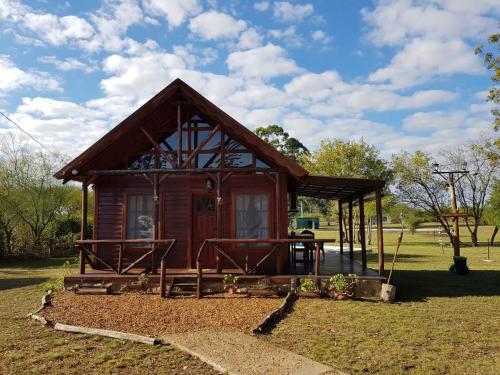 a small cabin in a field with a sky at Posada Los Molles in Colón