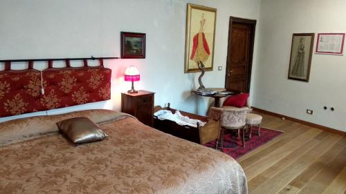 a bedroom with a bed and a table and a chair at Porta Rose in Garessio