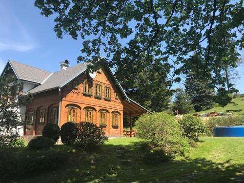 a large wooden house on a green lawn at Chalupa Lužické hory in Dolní Světlá
