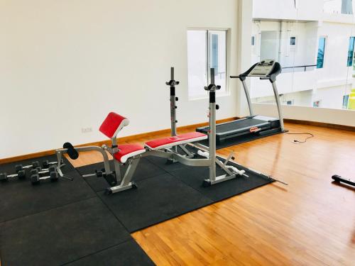 a gym with a treadmill and a chair in a room at Araliya OceanFront Condos Nilaveli, Trincomalee in Nilaveli