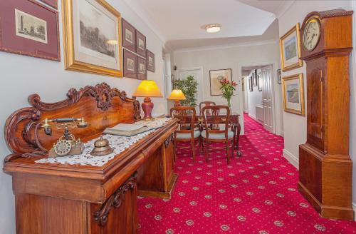 a room with a wooden desk and a dining room at Abbey Lodge in Killarney