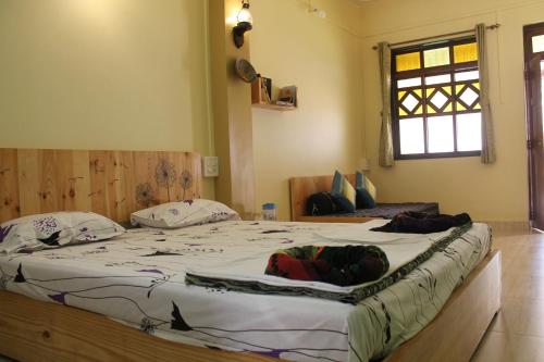 a bedroom with a large bed in a room at Sai Homestay in Malvan