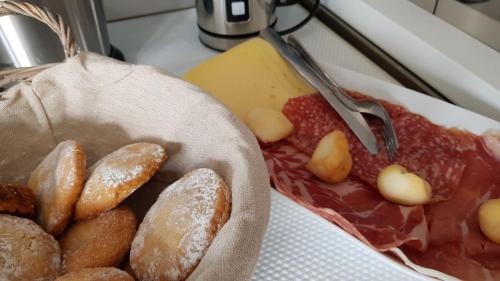 a bunch of different types of donuts on a counter at B&B Vistamare Suite in Agropoli
