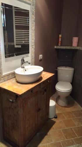 a bathroom with a sink and a toilet at L'ilot de Carpentras in Carpentras