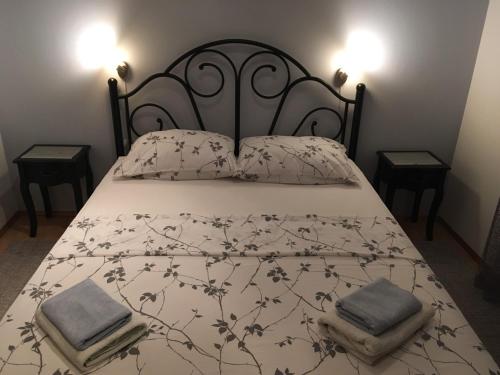 a bed with a black and white bedspread and pillows at Apartment Barica in Trsteno