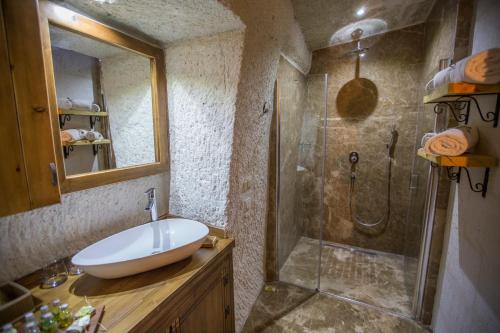 a bathroom with a sink and a shower at Agarta Cave Hotel in Goreme