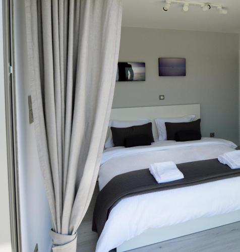 a bedroom with two beds and a curtain at Athens Riviera Loft in Athens