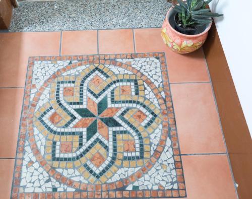 a mosaic tile floor with a cactus on it at Melina's House in Tramonti