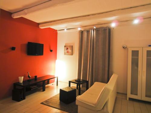a living room with a couch and a tv on the wall at Villino Erminia - Seaside Art b&b in Pizzo