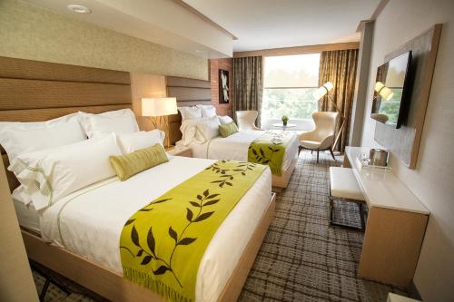 a hotel room with two beds and a desk at The Fredonia Hotel in Nacogdoches