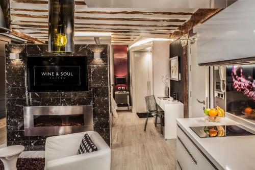 a kitchen with a living room with a fireplace at Wine & Soul Suites in Haro