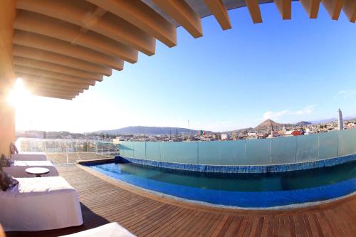 a swimming pool on the roof of a building at Hotel Real de Don Juan in Tepic